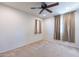 Spacious bedroom with ceiling fan and tan curtains at 11040 E Tumbleweed Ave, Mesa, AZ 85212
