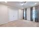 Well-lit bedroom featuring ceiling fan, double doors, and gray curtains at 11040 E Tumbleweed Ave, Mesa, AZ 85212