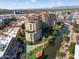 Aerial view of luxury condos and waterway with mountain backdrop at 7175 E Camelback Rd # 107, Scottsdale, AZ 85251