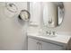 Modern bathroom with white vanity and a large mirror at 7175 E Camelback Rd # 107, Scottsdale, AZ 85251