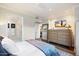 Main bedroom with large dresser, ensuite bathroom access, and a ceiling fan at 7175 E Camelback Rd # 107, Scottsdale, AZ 85251