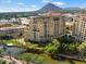 Aerial view of luxury condos with mountain views and a canal at 7175 E Camelback Rd # 107, Scottsdale, AZ 85251