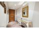 Elegant entryway with hardwood floors, a large mirror, and a console table at 7175 E Camelback Rd # 107, Scottsdale, AZ 85251