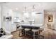 Modern white kitchen with a large island, quartz countertops, and stainless steel appliances at 7175 E Camelback Rd # 107, Scottsdale, AZ 85251