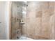 Spa-like shower with glass enclosure and beige tile at 7175 E Camelback Rd # 107, Scottsdale, AZ 85251