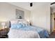 Spacious bedroom with king bed, ample closet space, and a ceiling fan at 20121 N 76Th St # 2022, Scottsdale, AZ 85255