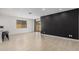 Open dining area with a black accent wall and modern lighting at 5837 N 89Th Dr, Glendale, AZ 85305