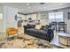 Open living room with dark gray couch and view into the kitchen at 5837 N 89Th Dr, Glendale, AZ 85305