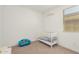 Bedroom with crib, armchair and decorative wall art at 5837 N 89Th Dr, Glendale, AZ 85305
