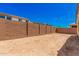 Sandy backyard with block wall and small grassy area at 5837 N 89Th Dr, Glendale, AZ 85305