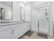 Modern bathroom with double vanity and walk-in shower at 5837 N 89Th Dr, Glendale, AZ 85305