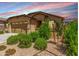 Tan house with a two-car garage and landscaping at 5837 N 89Th Dr, Glendale, AZ 85305