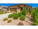 Tan house with a two-car garage and landscaping at 5837 N 89Th Dr, Glendale, AZ 85305