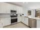 Modern kitchen with stainless steel appliances and white cabinets at 5837 N 89Th Dr, Glendale, AZ 85305