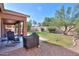 Landscaped backyard with covered patio at 1594 E Desert Breeze Dr, Casa Grande, AZ 85122