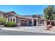 House exterior featuring a two-car garage and solar panels at 1594 E Desert Breeze Dr, Casa Grande, AZ 85122