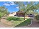 Spacious backyard with grassy lawn, covered patio, and spa at 1594 E Desert Breeze Dr, Casa Grande, AZ 85122