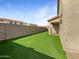 Artificial turf backyard with covered patio and block wall at 2341 E 28Th Ave, Apache Junction, AZ 85119