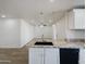 Modern kitchen features granite countertops and white cabinetry at 2711 N Olympic Cir, Mesa, AZ 85215