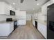 Open concept kitchen with granite counters and stainless steel appliances at 2711 N Olympic Cir, Mesa, AZ 85215