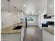 Bright kitchen with granite countertops, white cabinets, and modern appliances at 2711 N Olympic Cir, Mesa, AZ 85215