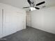 Bright bedroom with grey carpet and ceiling fan at 2711 N Olympic Cir, Mesa, AZ 85215