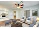 Bright living room with staged furniture and view into kitchen at 14300 W Bell Rd # 35, Surprise, AZ 85374