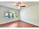 Bright bedroom with large window, hardwood floor and ceiling fan at 14300 W Bell Rd # 35, Surprise, AZ 85374