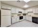 White kitchen with black appliances and ample counter space at 14300 W Bell Rd # 35, Surprise, AZ 85374