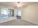 Bedroom with sliding door to patio and an adjacent room at 14300 W Bell Rd # 35, Surprise, AZ 85374