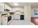 Bright kitchen with white cabinets and view of living room at 14300 W Bell Rd # 35, Surprise, AZ 85374