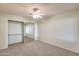 Bright bedroom featuring a mirrored closet and ceiling fan at 14300 W Bell Rd # 35, Surprise, AZ 85374