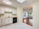 Kitchen with white cabinets, black appliances and view to living area at 14300 W Bell Rd # 35, Surprise, AZ 85374