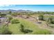 Aerial view showing large lot with mature trees and mountain backdrop at 11005 W Lower Buckeye Rd, Tolleson, AZ 85353