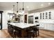 Gourmet kitchen with white cabinetry, large island, and stainless steel appliances at 19621 N 96Th Pl, Scottsdale, AZ 85255