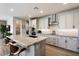 Modern kitchen with large island and white cabinets at 16143 W Charlotte Dr, Surprise, AZ 85387