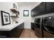 Modern laundry room with quartz countertops, black cabinetry, and high-end washer and dryer at 6201 E Calle Redonda --, Scottsdale, AZ 85251