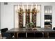 Modern dining room with a large wooden table and a glass-enclosed wine rack at 6201 E Calle Redonda --, Scottsdale, AZ 85251