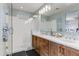 Modern bathroom with double vanity, large mirror and glass shower at 7347 E Casitas Del Rio Dr, Scottsdale, AZ 85255