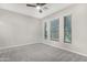 Spacious bedroom with neutral walls and carpet, featuring three large windows with blinds at 32029 N 20Th Ln, Phoenix, AZ 85085