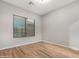 Light and airy bedroom with wood-look floors and window blinds at 32029 N 20Th Ln, Phoenix, AZ 85085