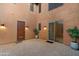 Private courtyard with brick pavers, potted plants, and a security door at 32029 N 20Th Ln, Phoenix, AZ 85085