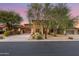 Two-story home with covered entryway and mature trees at dusk at 32029 N 20Th Ln, Phoenix, AZ 85085