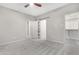 Bright bedroom with grey carpet, barn door, and walk-in closet at 32029 N 20Th Ln, Phoenix, AZ 85085