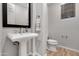 Modern powder room with pedestal sink and wood-look floors at 32029 N 20Th Ln, Phoenix, AZ 85085