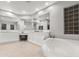 Elegant bathroom with double vanity, soaking tub, and glass block windows at 32029 N 20Th Ln, Phoenix, AZ 85085