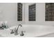 Close up of a corner bathtub with glass block windows at 32029 N 20Th Ln, Phoenix, AZ 85085