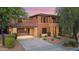 Two-story home exterior with a covered carport and desert landscaping at 32029 N 20Th Ln, Phoenix, AZ 85085