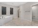 Spa-like bathroom with soaking tub, shower, and tiled floors at 32029 N 20Th Ln, Phoenix, AZ 85085
