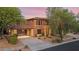 Two-story home exterior with a covered carport and desert landscaping at 32029 N 20Th Ln, Phoenix, AZ 85085